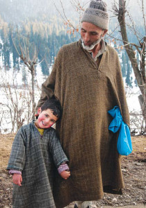 Rosy cheeked Muskaan, a little kashmiri girl with her grandfather