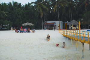 Tourists enjoying on the white sandy beach