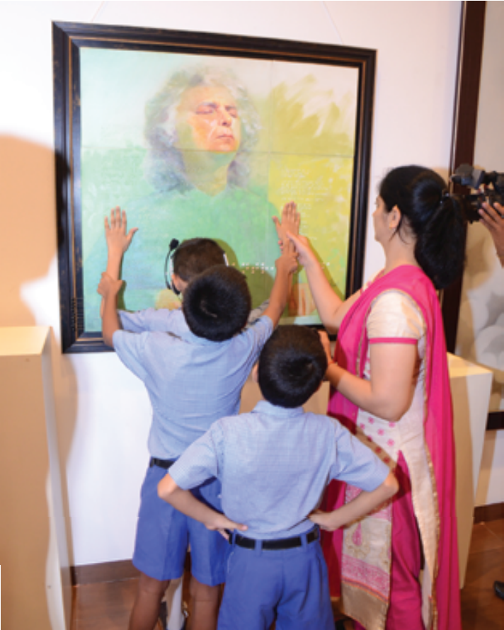Visually impaired students “seeing” the portrait of Santoor maestro Shivkumar Sharma by feeling it